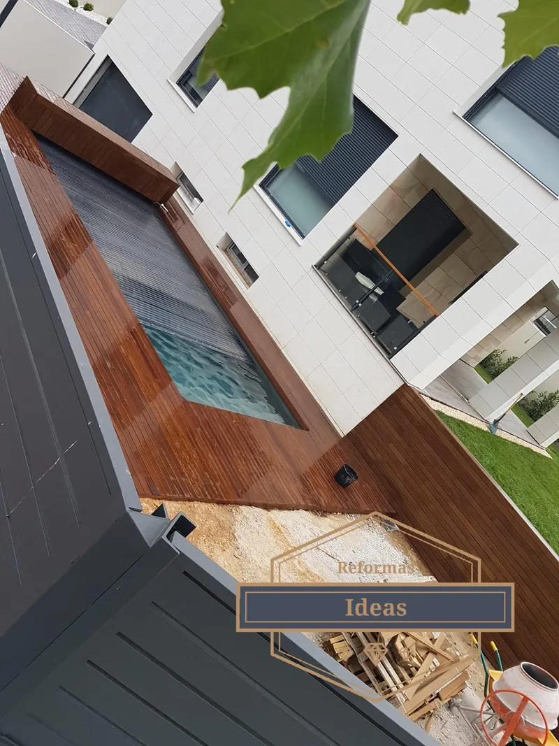 Vista aérea de una reforma exterior con tarima de madera y piscina